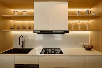 Modern kitchen with sleek cabinetry and built-in appliances, featuring elegant lighting and minimalist design.