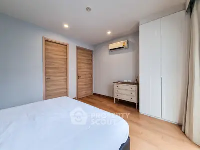 Spacious bedroom with modern design and ample natural light