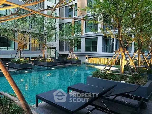 Luxurious modern apartment complex with stunning pool and lush greenery