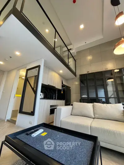 Modern loft apartment with stylish interior and open layout, featuring a cozy living area and sleek kitchen.