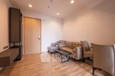 Modern living room with stylish furniture and wooden flooring in a cozy apartment.