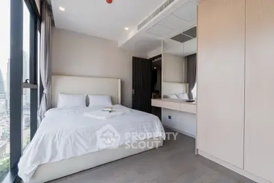 Modern bedroom with city view, featuring sleek design and ample natural light.