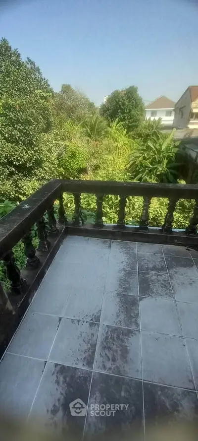 Charming balcony with lush garden view, perfect for relaxation and enjoying nature's tranquility.