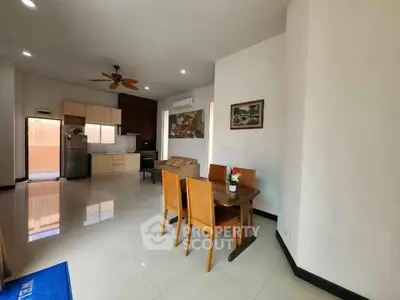 Spacious open-plan living and dining area with modern kitchen and stylish decor.