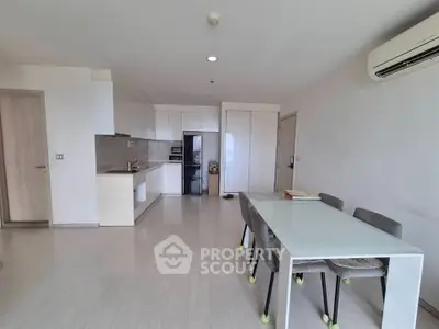 Spacious modern kitchen and dining area with sleek design and ample natural light.