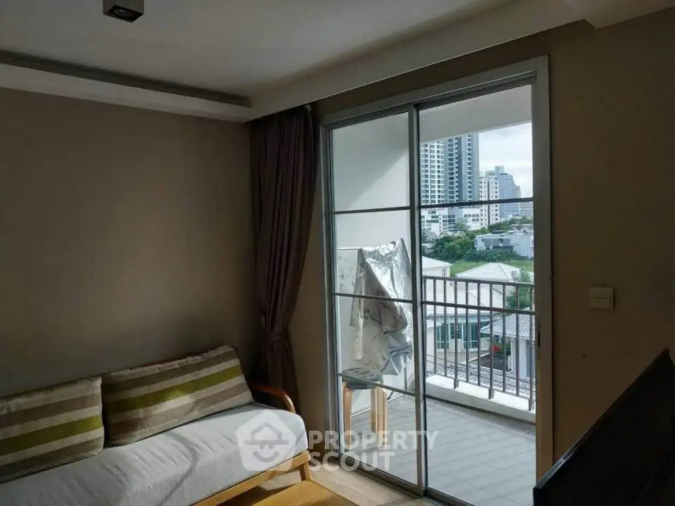 Cozy living room with balcony view in modern apartment