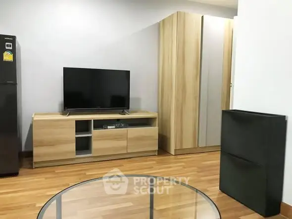Modern living room with sleek TV stand and wooden flooring