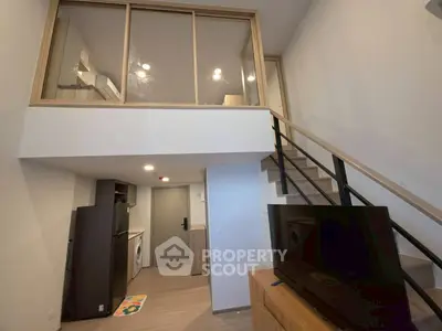 Modern duplex apartment with stylish interior and mezzanine level, featuring a sleek kitchen and cozy living area.