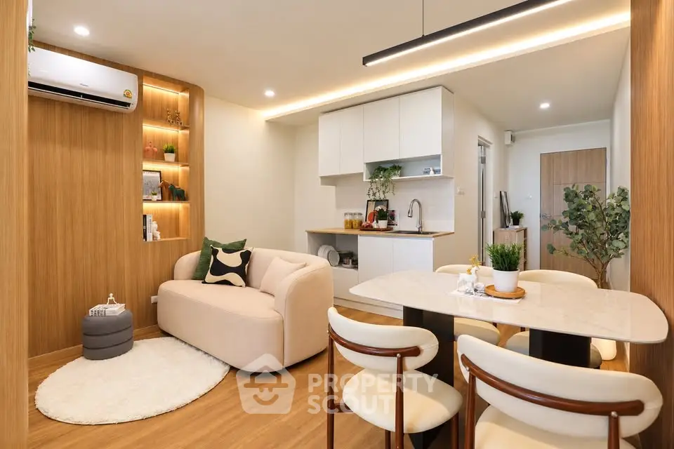 Modern open-plan living room and kitchen with stylish decor and cozy ambiance.