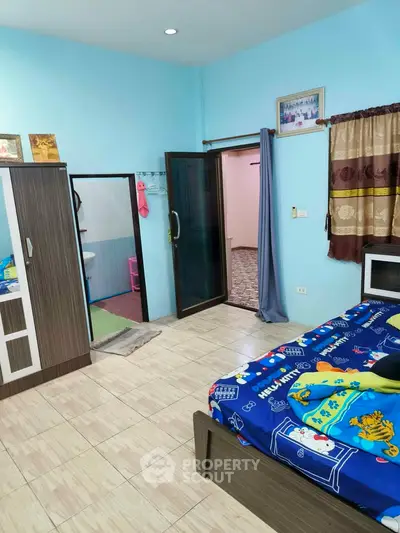 Cozy bedroom with vibrant decor and ample storage in a modern home.