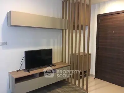 Modern living room with sleek TV stand and wooden partition, perfect for stylish urban living.