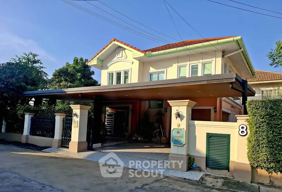 Charming two-story house with spacious driveway and lush greenery, perfect for family living.