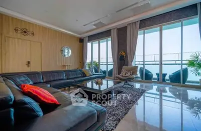 Luxurious living room with stunning ocean view and modern furnishings.