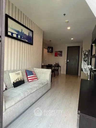 Stylish living room with modern decor and cozy seating in a contemporary apartment.