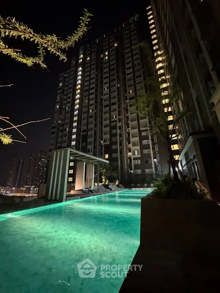 Stunning night view of illuminated high-rise building with luxurious pool