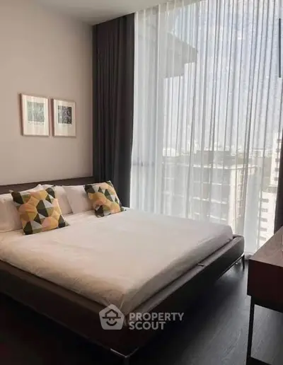 Modern bedroom with large window and stylish decor in urban apartment