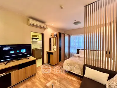 Modern studio apartment with open layout, featuring cozy living area and compact kitchen.