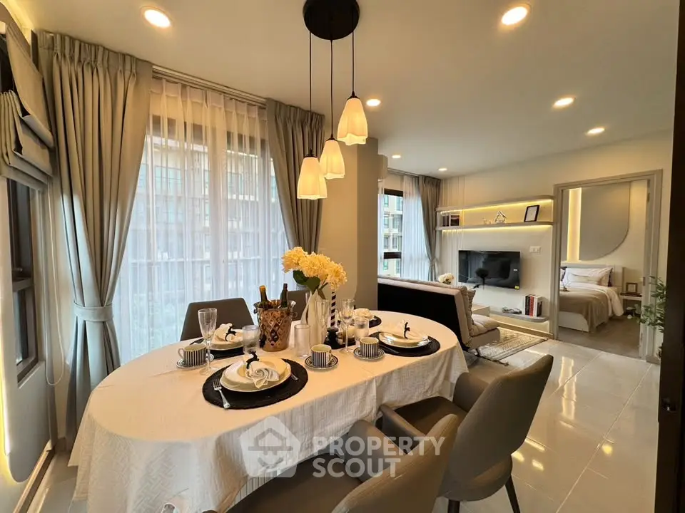 Elegant dining and living area with modern decor and natural light