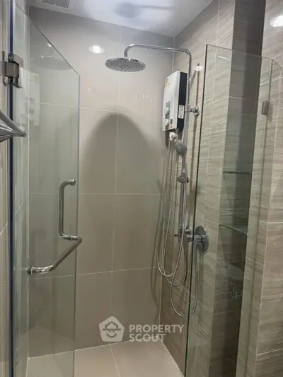 Modern bathroom with glass shower enclosure and sleek fixtures