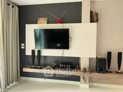 Modern living room with wall-mounted TV and stylish decor