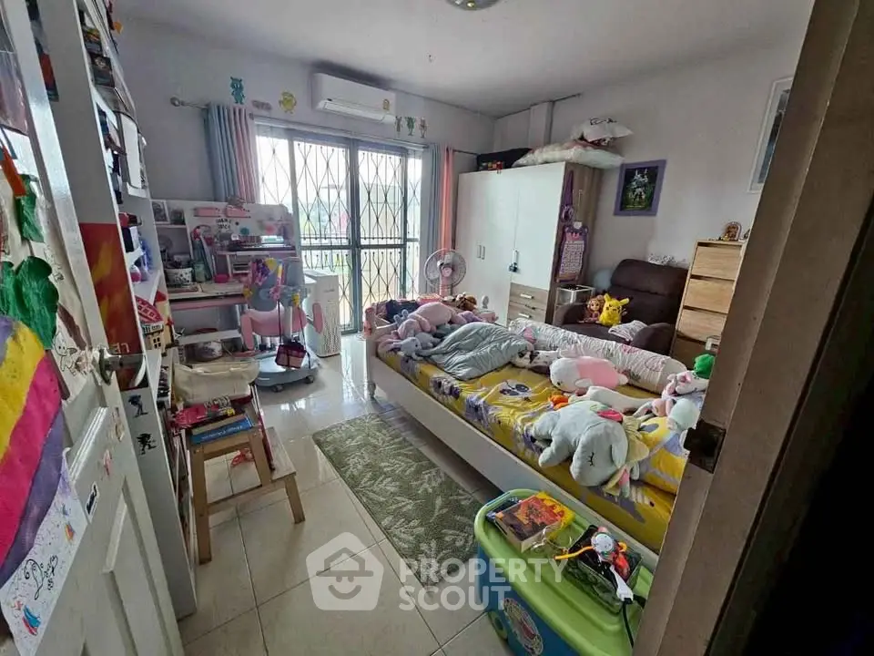 Charming bedroom with balcony access, perfect for a cozy and playful atmosphere.
