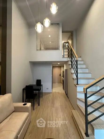 Modern duplex living room with high ceiling and stylish staircase