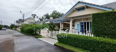 Charming suburban houses with lush greenery and well-maintained exteriors on a quiet street.