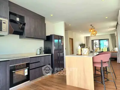 Modern kitchen with sleek appliances and open layout in a stylish apartment.