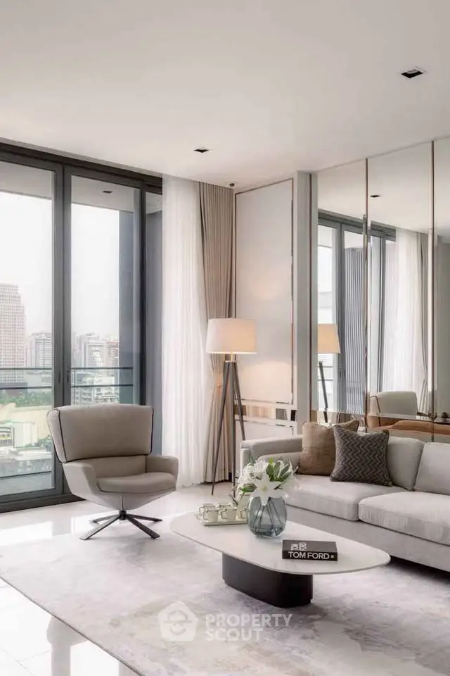 Luxurious modern living room with floor-to-ceiling windows and elegant decor in a high-rise apartment.