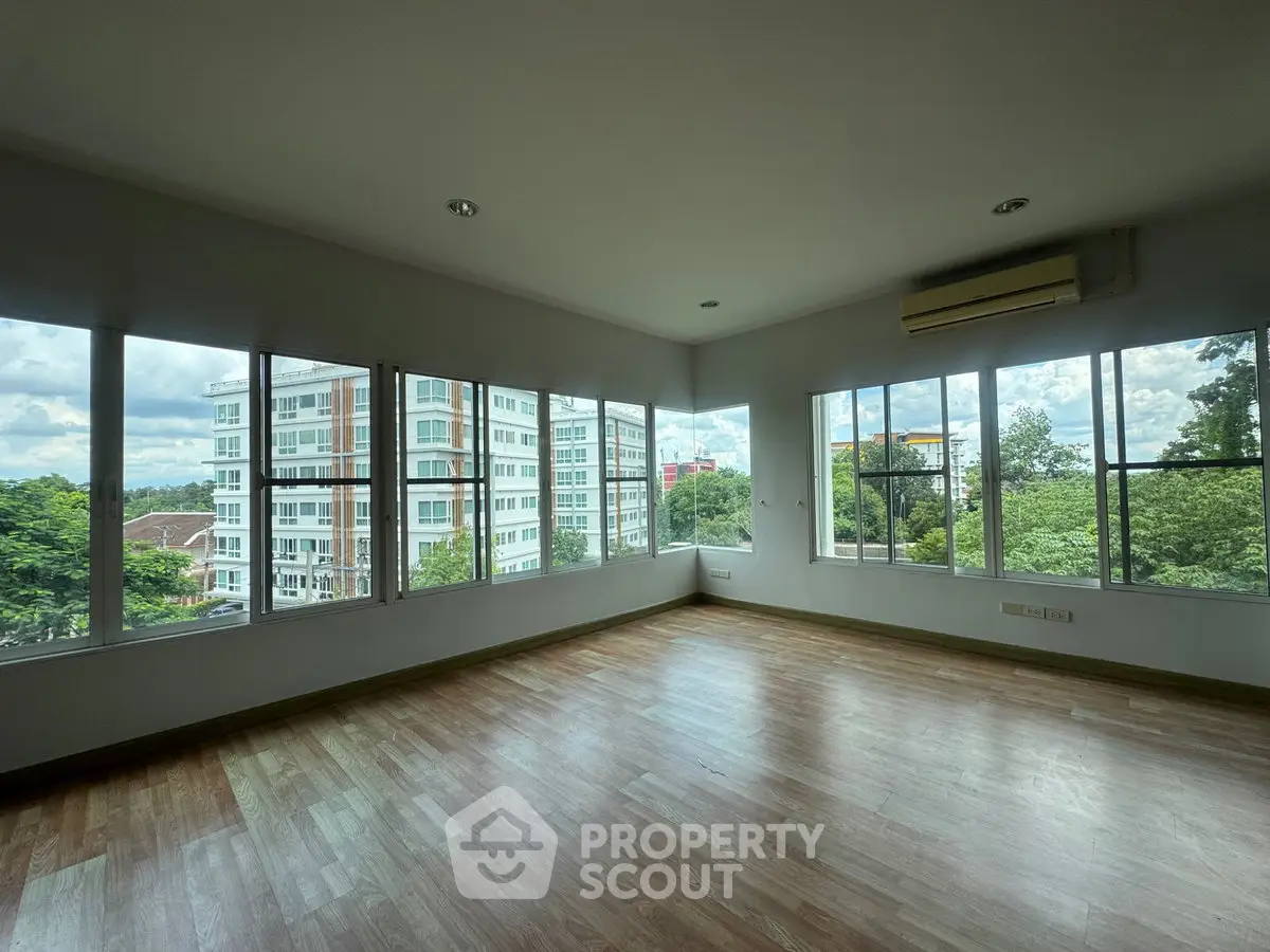 Spacious corner unit with large windows offering a stunning view of the cityscape and greenery.