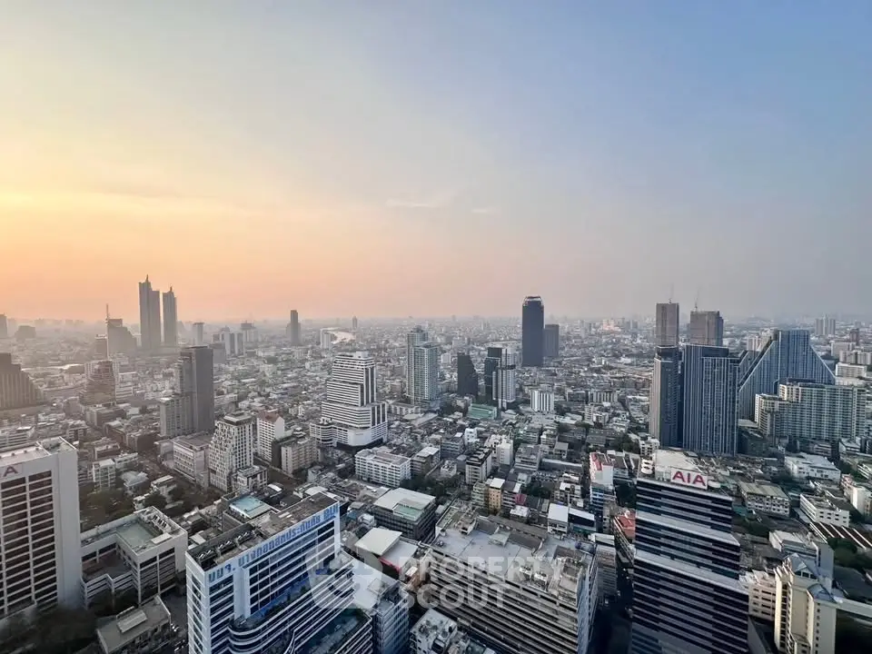 Stunning cityscape view from a high-rise building at sunset, showcasing urban skyline and architecture.