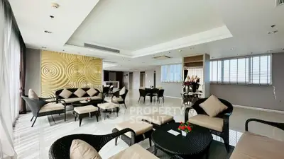 Spacious and elegant living room with modern decor and ample natural light.