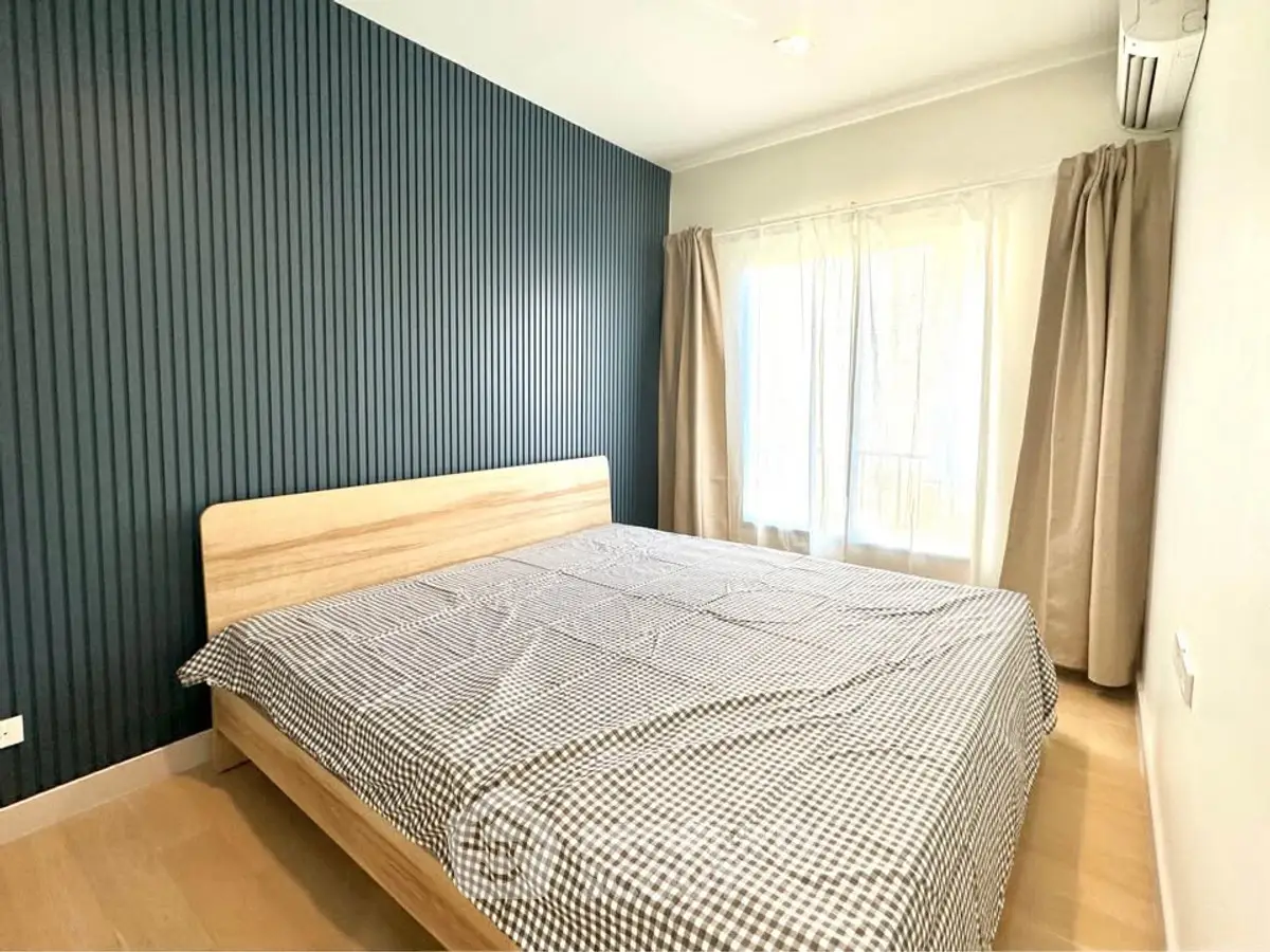 Modern bedroom with stylish accent wall and natural light