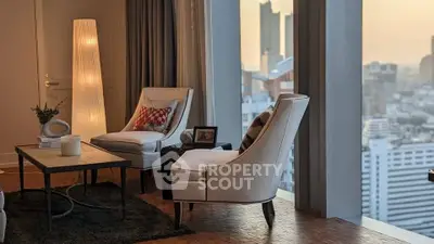 Luxurious living room with elegant chairs and stunning city view from high-rise apartment.