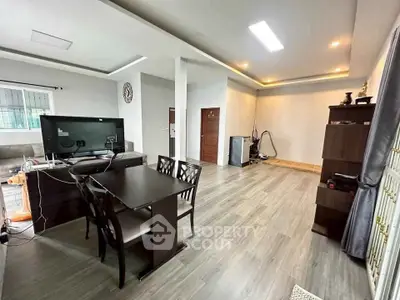 Spacious modern living room with elegant dining area and sleek flooring