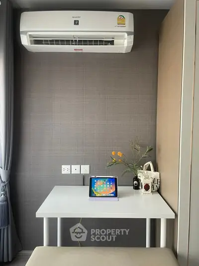 Modern study nook with air conditioning and sleek table setup