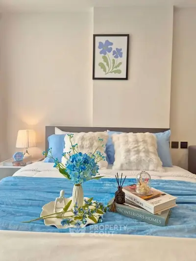 Elegant bedroom with plush bedding and stylish decor, perfect for a cozy retreat.