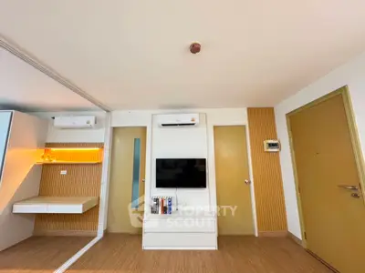 Modern living room with sleek design, featuring built-in storage and air conditioning.