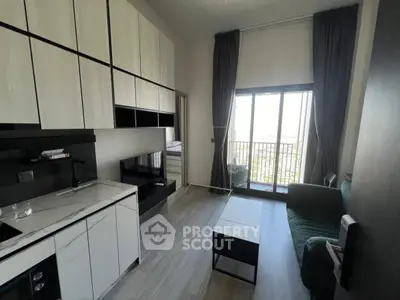 Modern living room with sleek kitchen and balcony view in stylish apartment