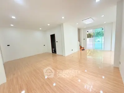 Spacious modern living room with glossy wooden floors and bright lighting