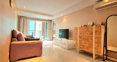 Spacious living room with modern decor and balcony access