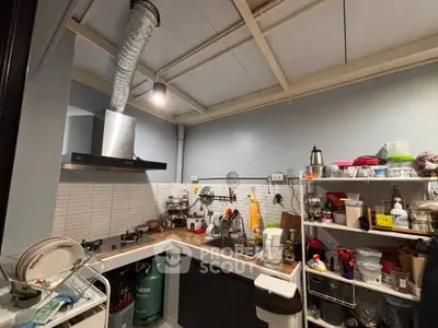 Cozy kitchen with modern appliances and ample storage space, perfect for culinary enthusiasts.