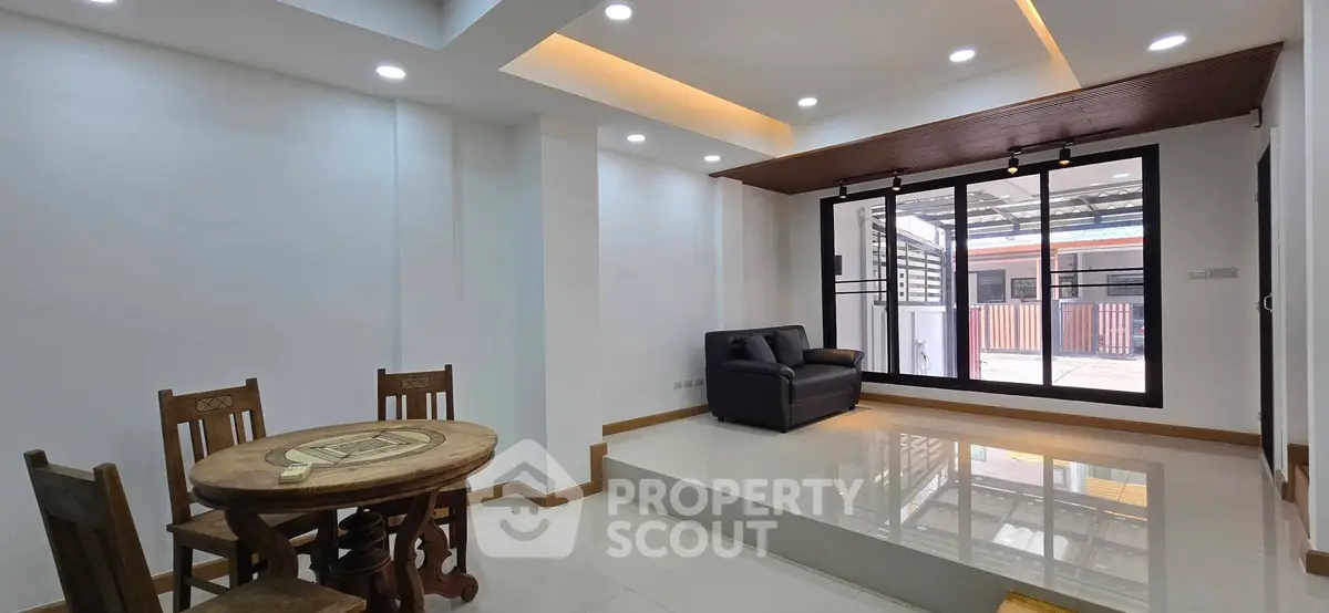Modern living room with sleek design and large windows offering ample natural light.