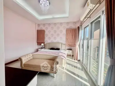Luxurious bedroom with elegant decor and ample natural light from large windows.