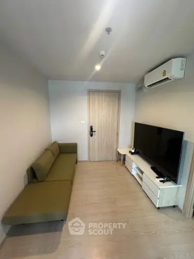 Modern living room with sleek furniture and air conditioning, perfect for cozy urban living.