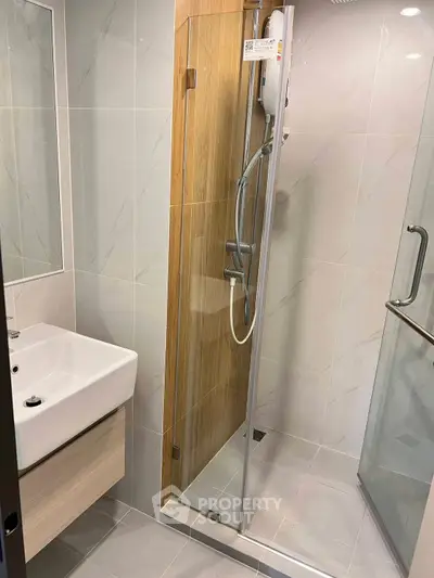 Modern bathroom with sleek shower and stylish sink in contemporary design.