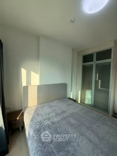 Bright and cozy bedroom with modern decor and ample natural light.