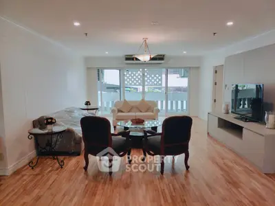 Spacious living room with elegant furniture and large windows offering natural light.