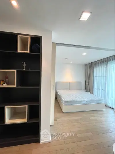 Spacious bedroom with modern design and large windows for natural light