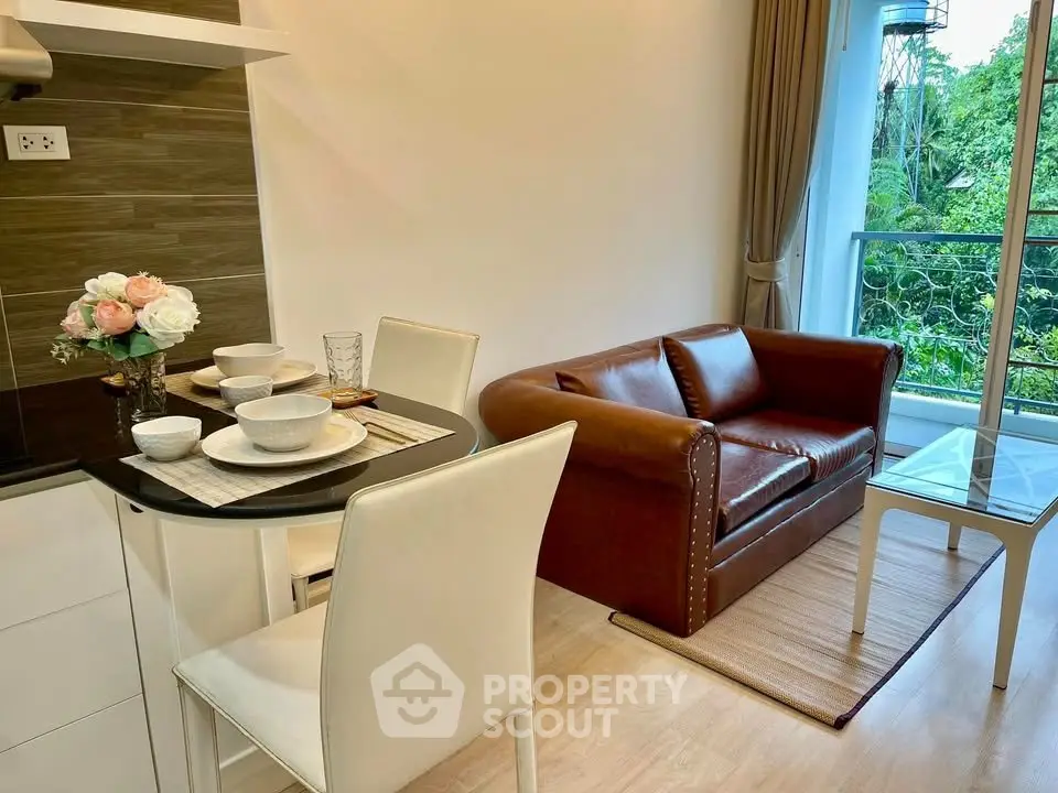 Charming living room with cozy leather sofa and elegant dining area overlooking lush greenery.